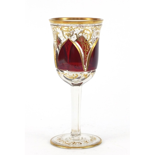 3917 - Bohemian red flashed glass goblet gilded with foliage, 20.5cm high