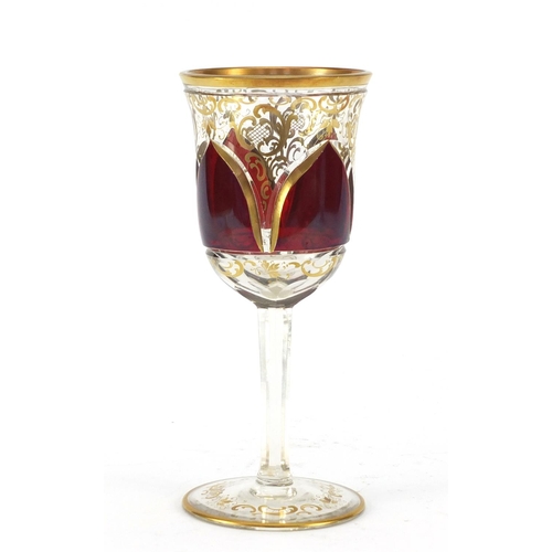 3917 - Bohemian red flashed glass goblet gilded with foliage, 20.5cm high