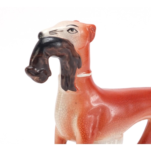 1179 - Staffordshire pottery whippet with game, 19cm high