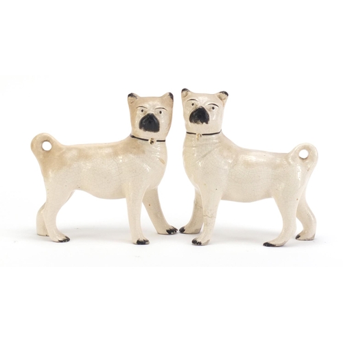 859 - Pair of Staffordshire pottery pug dogs, each 15cm in length