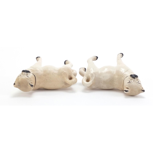 859 - Pair of Staffordshire pottery pug dogs, each 15cm in length