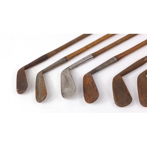 603 - Eight vintage wooden shafted golf clubs, the largest 96cm in length