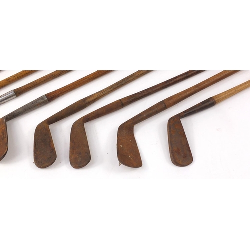 603 - Eight vintage wooden shafted golf clubs, the largest 96cm in length