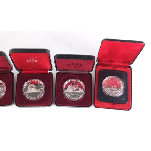 711 - Five Canadian silver dollars with cases