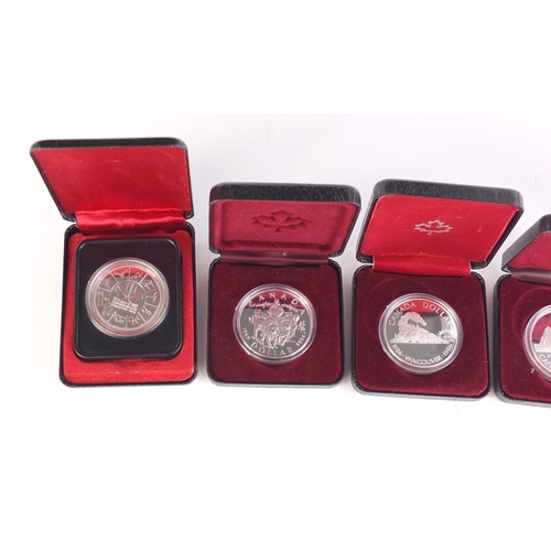 711 - Five Canadian silver dollars with cases