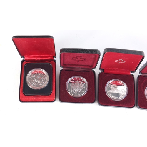 711 - Five Canadian silver dollars with cases