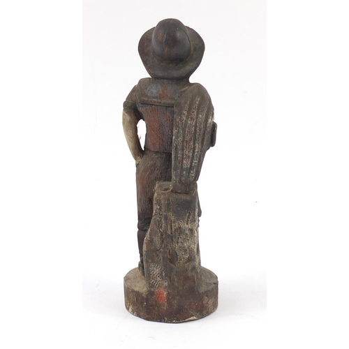 1448 - Polychrome painted wood carving of a farmer, 36cm high