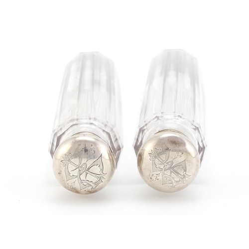 1490 - Pair of cut glass bottles with silver lids, each 18.5cm in length