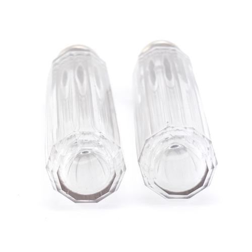 1490 - Pair of cut glass bottles with silver lids, each 18.5cm in length