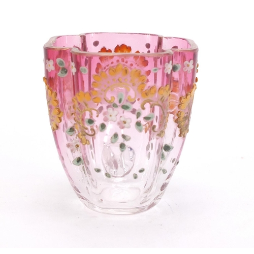 1492 - Continental glass cup and saucer enamelled with flowers, the saucer 13cm wide