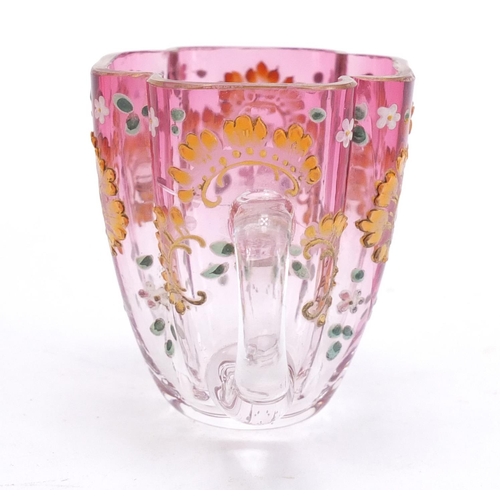 1492 - Continental glass cup and saucer enamelled with flowers, the saucer 13cm wide