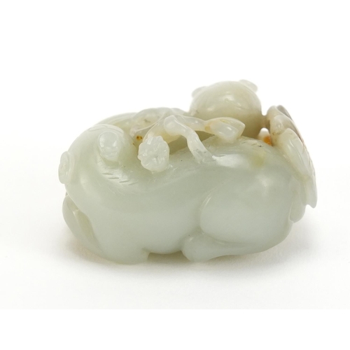 396 - Chinese celadon and russet jade carving of two mythical animals and a butterfly, 5cm wide