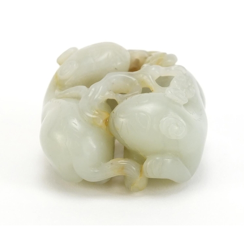 396 - Chinese celadon and russet jade carving of two mythical animals and a butterfly, 5cm wide