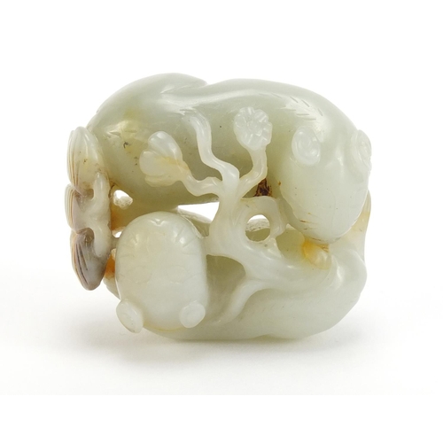 396 - Chinese celadon and russet jade carving of two mythical animals and a butterfly, 5cm wide