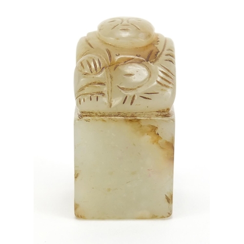 313 - Chinese green and russet jade desk seal carved with a Buddha, 4.3cm high