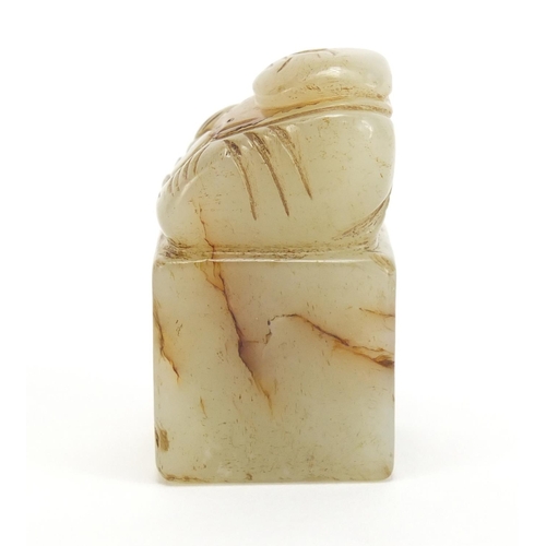 313 - Chinese green and russet jade desk seal carved with a Buddha, 4.3cm high