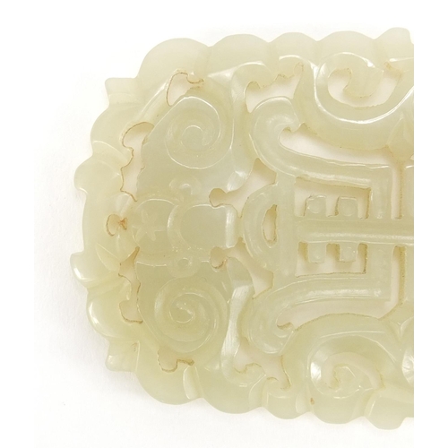 311 - Chinese pale green jade panel pierced and carved with two dragons and a bat, 6.5cm x 5cm