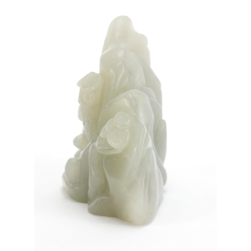 837 - Chinese pale green jade carving of a figure beside a tree before a mountain, 6cm high