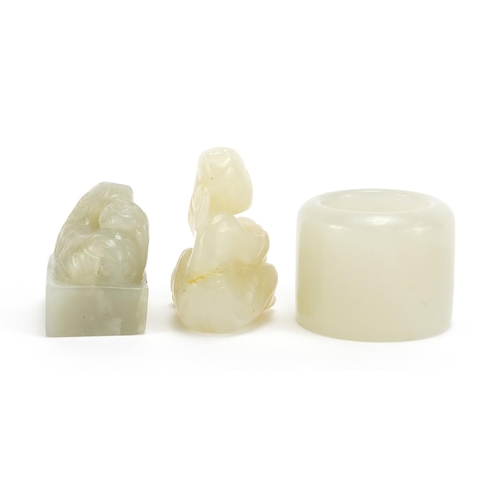 639 - Three Chinese pale green jade carvings including an archer's ring and dragon seal, the largest 4cm h... 