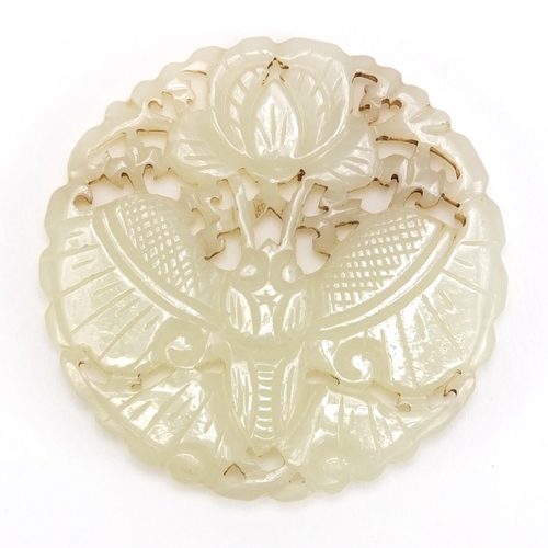 838 - Chinese pale jade disc, pierced and carved with a bat and flowers, 5.5cm in diameter