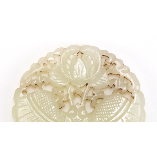 838 - Chinese pale jade disc, pierced and carved with a bat and flowers, 5.5cm in diameter