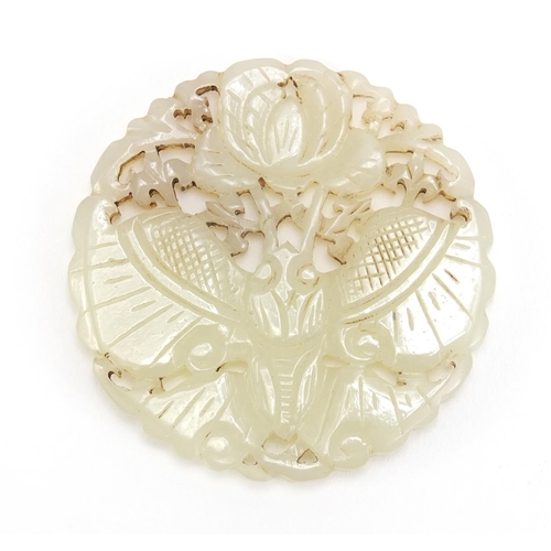 838 - Chinese pale jade disc, pierced and carved with a bat and flowers, 5.5cm in diameter