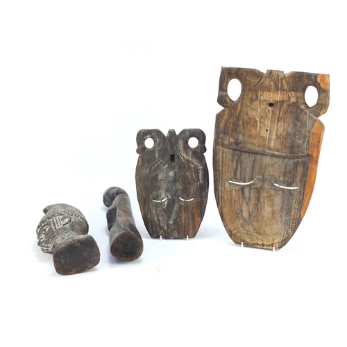 1509 - Four wood carvings including two tribal face masks, the largest 49.5cm high