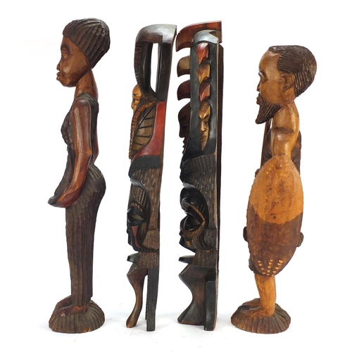 1507 - Four tribal wood carvings including a tribesman and two face masks, the largest 60cm high