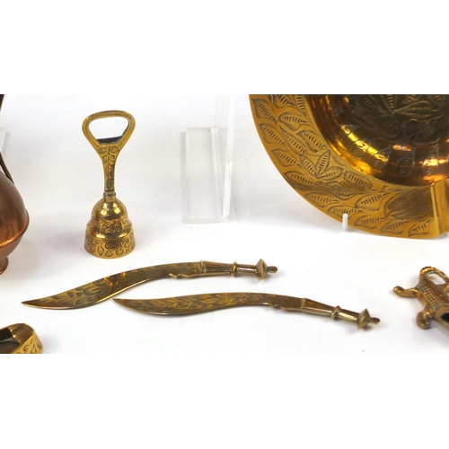 1413 - Copper and brassware including jugs and pair of candlesticks, the largest 25.5cm in diameter