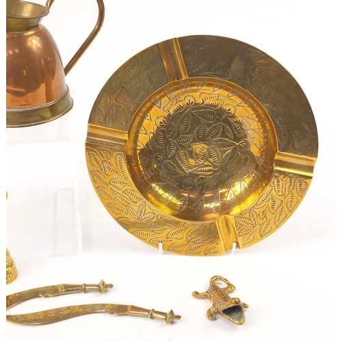 1413 - Copper and brassware including jugs and pair of candlesticks, the largest 25.5cm in diameter