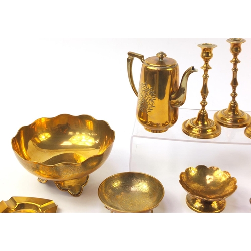 1413 - Copper and brassware including jugs and pair of candlesticks, the largest 25.5cm in diameter