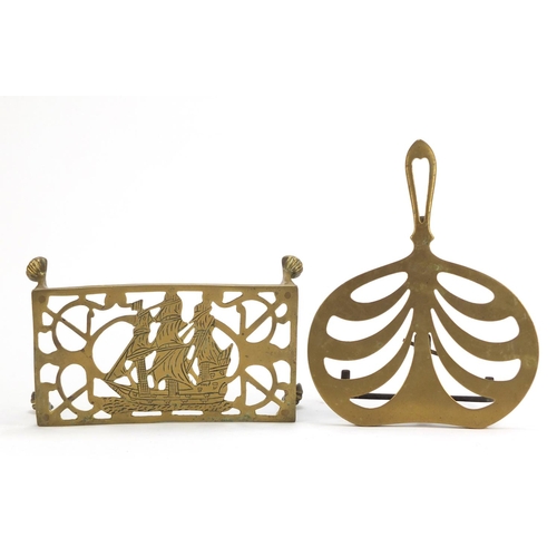 1254 - Two antique brass trivets including one decorated with a ship impressed Regd, the largest 28cm wide