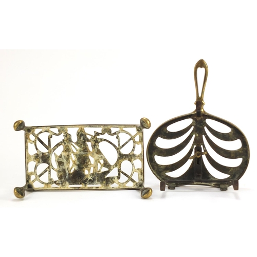 1254 - Two antique brass trivets including one decorated with a ship impressed Regd, the largest 28cm wide