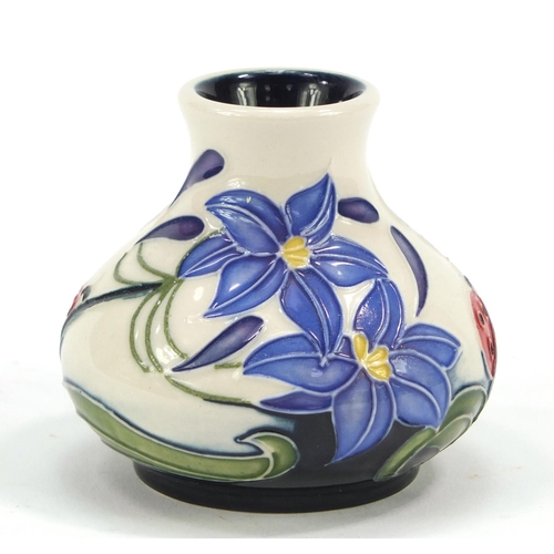 421 - Moorcroft pottery vase hand painted with a ladybird and flowers, dated 2005, 6cm high