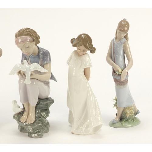 916 - Five Lladro and Nao figurines including a girl holding a basket of flowers, the largest 25.5cm high