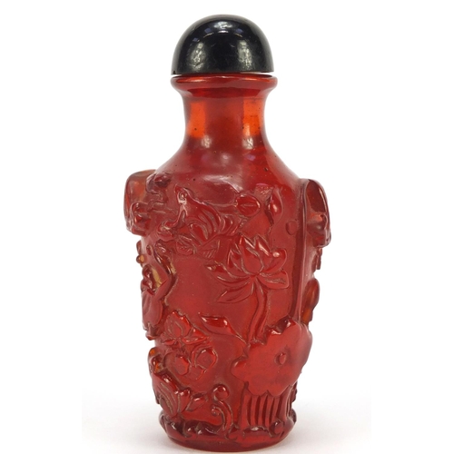 1544 - Chinese cherry amber coloured snuff bottle decorated with flowers, 10cm high