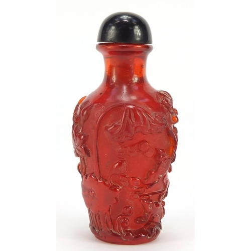 1544 - Chinese cherry amber coloured snuff bottle decorated with flowers, 10cm high