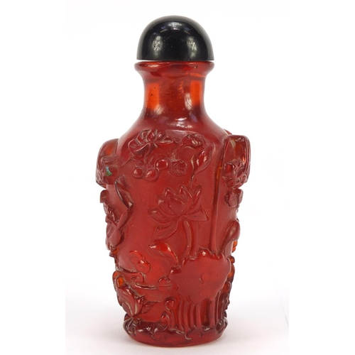 1544 - Chinese cherry amber coloured snuff bottle decorated with flowers, 10cm high