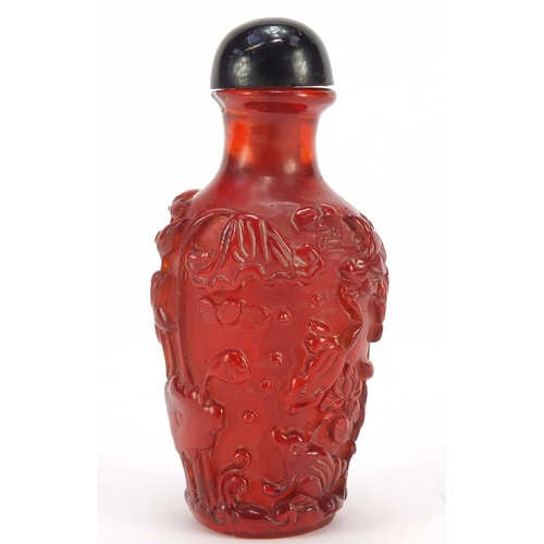 1544 - Chinese cherry amber coloured snuff bottle decorated with flowers, 10cm high