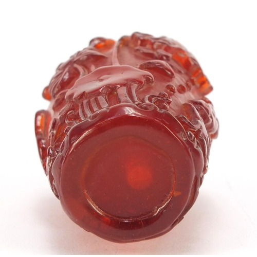 1544 - Chinese cherry amber coloured snuff bottle decorated with flowers, 10cm high