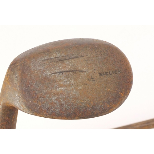 604 - Two wooden shafted Niblick golf clubs including one stamped Eastbourne, the largest 97cm in length