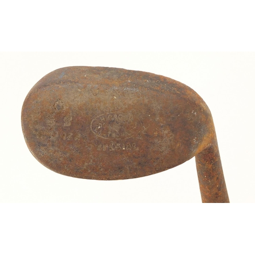 604 - Two wooden shafted Niblick golf clubs including one stamped Eastbourne, the largest 97cm in length