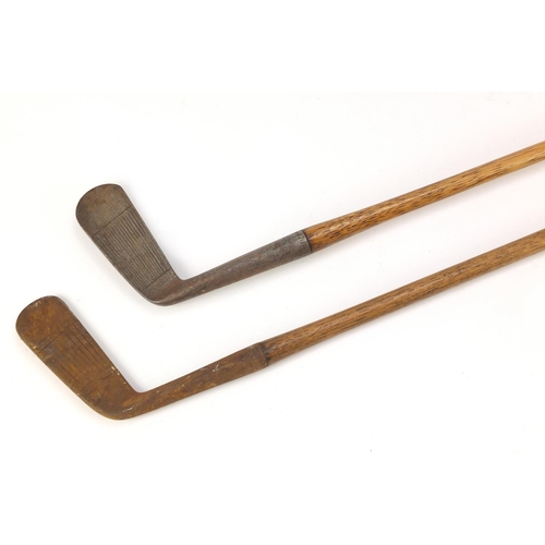 774 - Two wooden shafter putters including one by H E Pearse, the largest 89cm in length