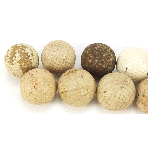 606 - Twelve vintage golf balls including Slazenger, Penfold and Warwick