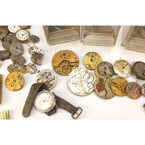 483A - Collecton of Antique and later watch parts including crystals, movements and straps