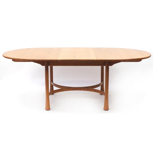 1596 - Ercol elm oval extending dining table with four chairs, the table 94.5cm H x 163cm W x 107.5cm D