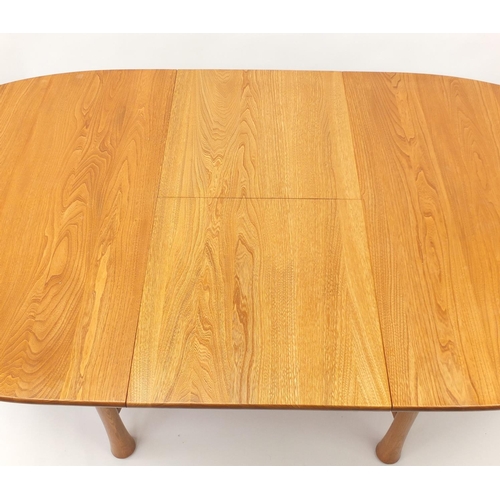 1596 - Ercol elm oval extending dining table with four chairs, the table 94.5cm H x 163cm W x 107.5cm D