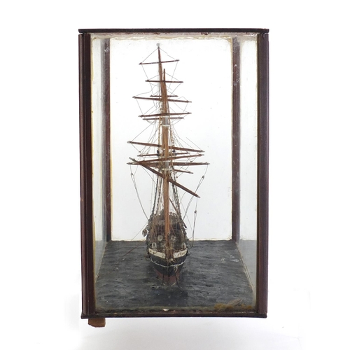 973 - Wooden model of a rigged sailing ship housed in a mahogany and glass display case, 32.5cm H x 42.5cm... 