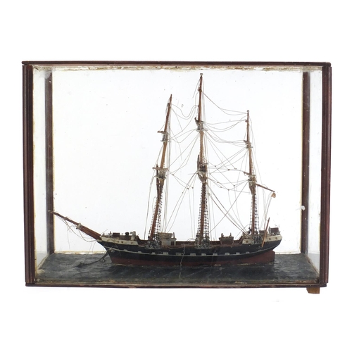 973 - Wooden model of a rigged sailing ship housed in a mahogany and glass display case, 32.5cm H x 42.5cm... 