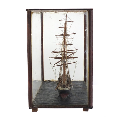 973 - Wooden model of a rigged sailing ship housed in a mahogany and glass display case, 32.5cm H x 42.5cm... 